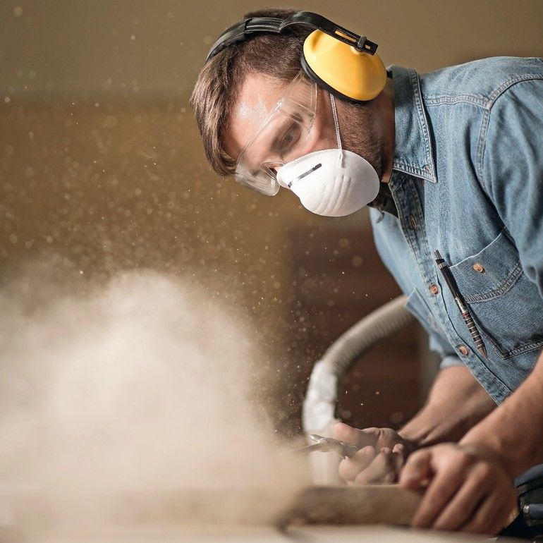 Carpenter_wearing_protective_headphones_while_using_electric_saw