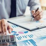 Business_man_or_accountant_working_Financial_investment_on_calculator_with_calculate_Analyze_business_and_market_growth_on_financial_document_data_graph_and_writing_,Accounting,Economic,commercial.