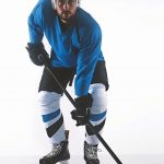 Portrait_of_Caucasian_male_ice_hockey_player_in_uniform_posing_against_white_background