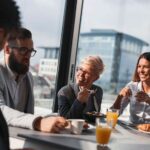 Group_of_business_people_having_breakfast_in_company's_restaurant._Focus_on_the_woman_in_the_middle