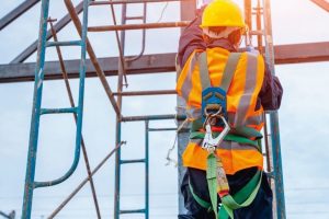 Construction_worker_wearing_safety_harness_belt_during_working_at_high_place.