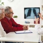 Doctor_shows_results_to_old_patient_x-ray_of_the_lungs_at_clinic