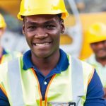 happy_african_american_construction_worker_in_front_of_colleagues