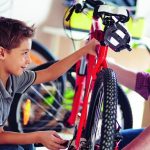 Father_helping_his_son_fix_a_bicycle