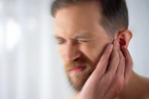 Man_feels_pain_in_middle_ear,_meningitis_and_hearing_loss,_inflammation,_closeup