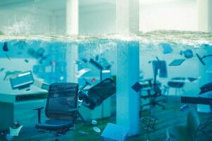 interior_of_an_office_completely_flooded,_objects_floating_in_water_and_selective_focus_on_a_chair._3d_image_render._concept_of_problems_at_work.
