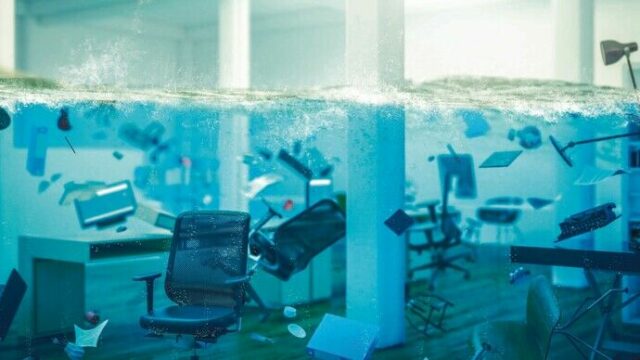 interior_of_an_office_completely_flooded,_objects_floating_in_water_and_selective_focus_on_a_chair._3d_image_render._concept_of_problems_at_work.