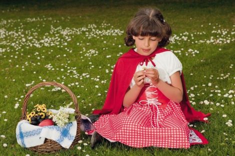Little_red_riding_hood_picking_daisy_flowers_in_grass