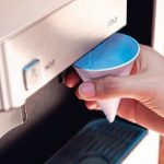Close_up_of_a_woman_hand_filling_a_paper_cup_of_water_from_the_water_cooling_machine.